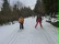 Schülerin beim Skilanglauf - begleitet von einem Skilehrer.